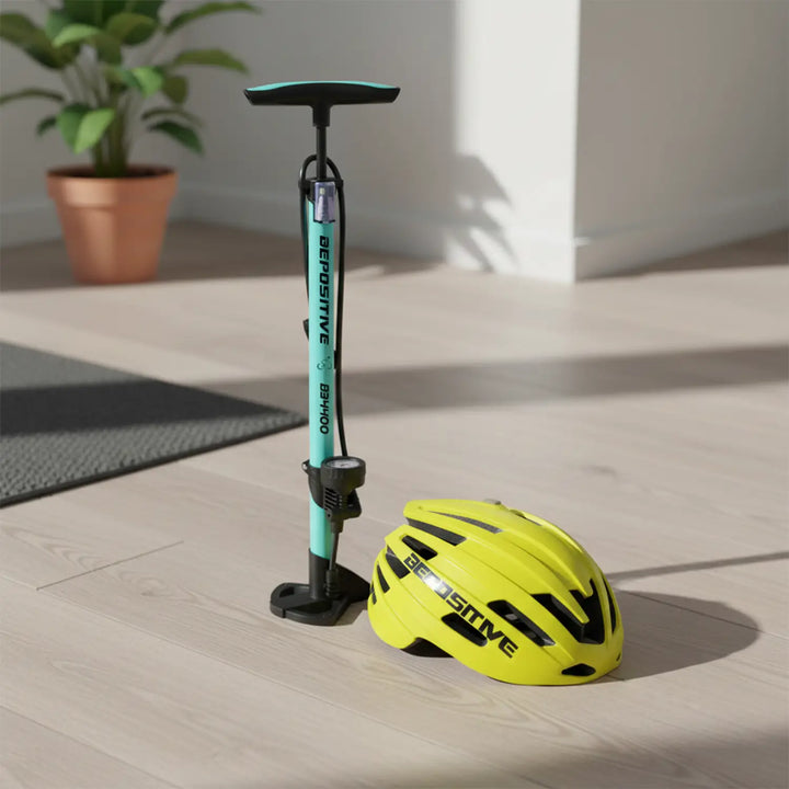 A yellow bepositive 5.2 cycling helmet and a bepositive 4400 turquoise blue pump on a wooden floor in the background