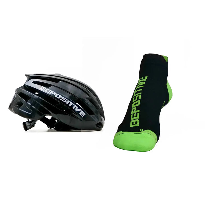 A black bepositive cycling helmet and green bepositive Ankle socks on a white background