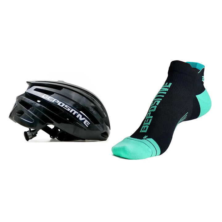 A black bepositive cycling helmet and turquoise blue bepositive Ankle socks on a white background