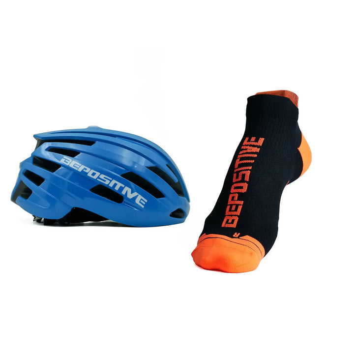 A blue bepositive cycling helmet and orange bepositive Ankle socks on a white background 