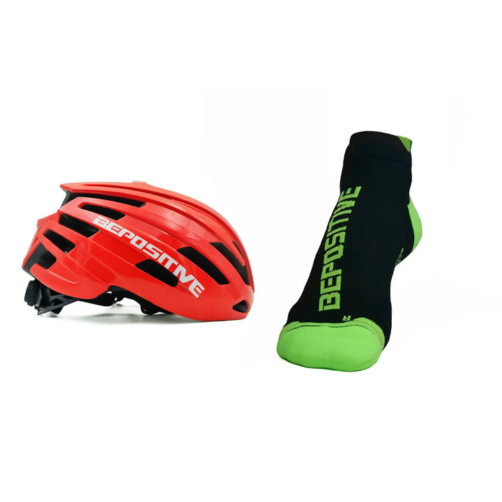 A orange bepositive cycling helmet and green bepositive Ankle socks on a white background