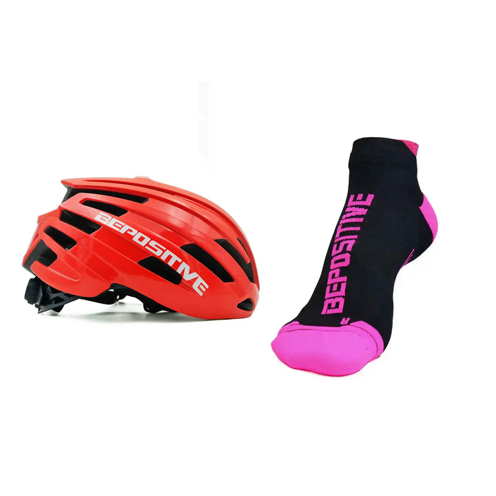 A orange bepositive cycling helmet and pink bepositive Ankle socks on a white background