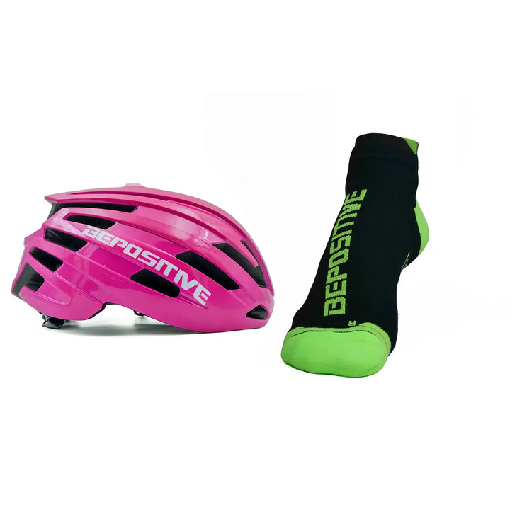 A pink bepositive cycling helmet and  green bepositive Ankle socks on a white background