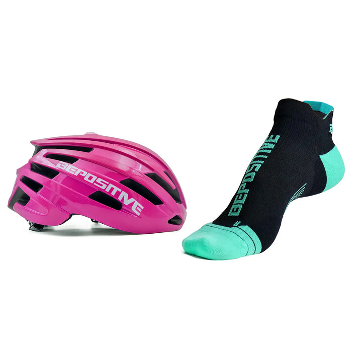A pink bepositive cycling helmet and  turquoise blue bepositive Ankle socks on a white background