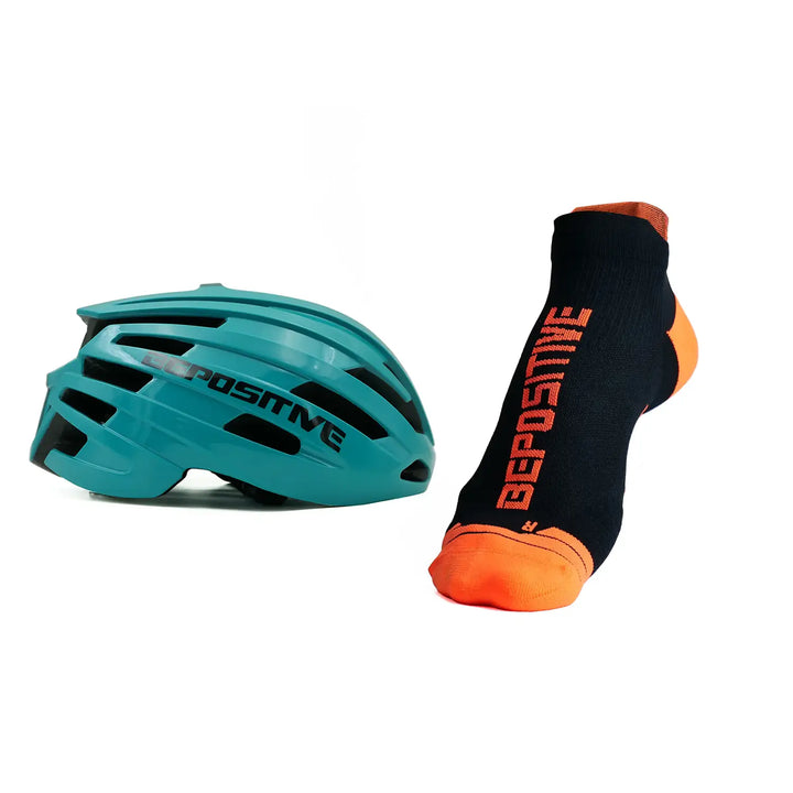 A turquoise blue bepositive cycling helmet and orange bepositive Ankle socks on a white background