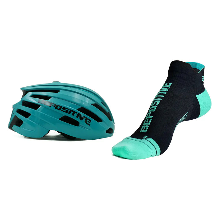 A turquoise blue bepositive cycling helmet and turquoise blue bepositive Ankle socks on a white background