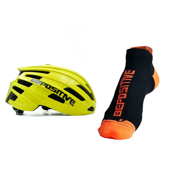 A yellow bepositive cycling helmet and orange bepositive Ankle socks on a white background