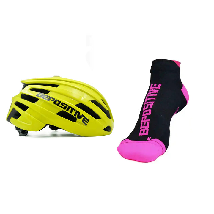 A yellow bepositive cycling helmet and pink bepositive Ankle socks on a white background