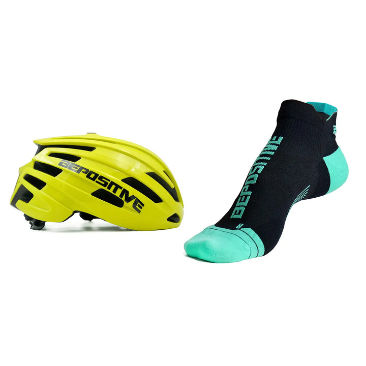 A yellow bepositive cycling helmet and turquoise blue bepositive Ankle socks on a white background