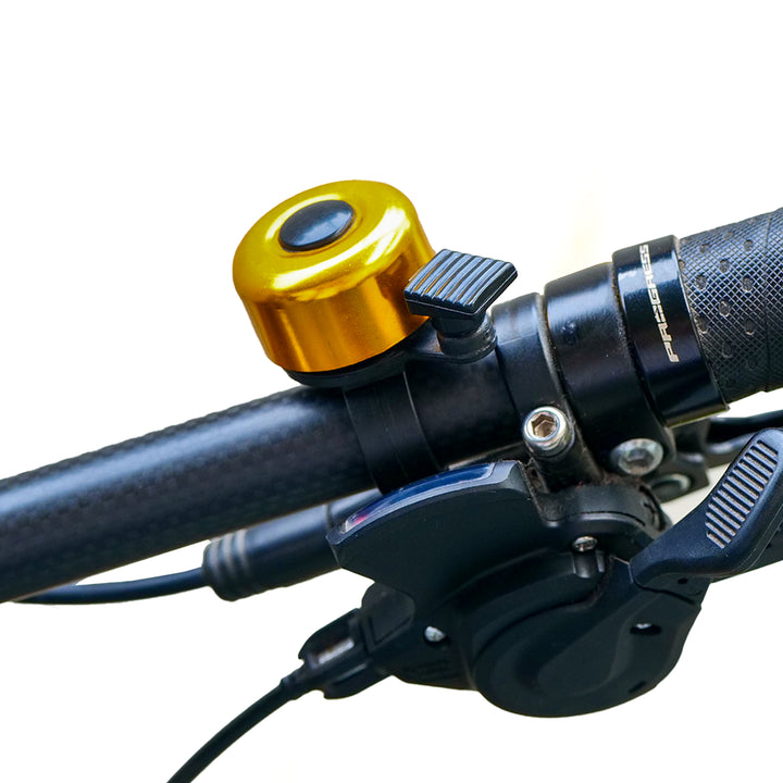 Cycle Chime Bell golden fitted on a bicycle handlebar
 