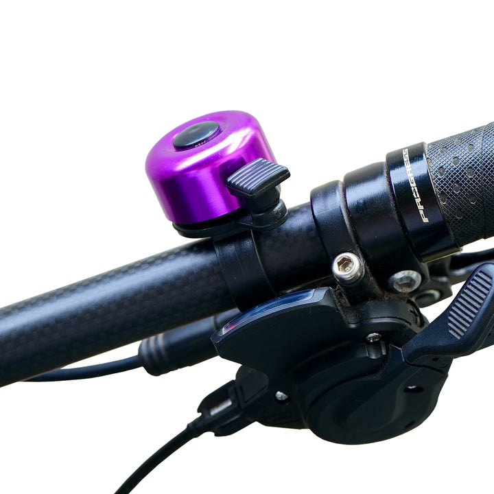 Cycle Chime Bell purple fitted on a bicycle handlebar
