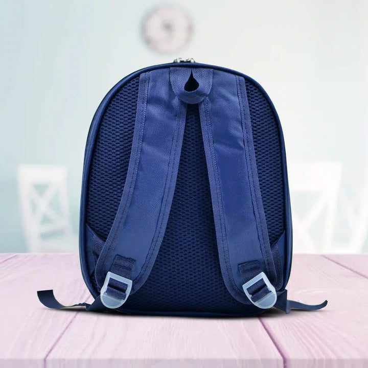 Back view of a Blue backpack on a pink surface with a blurred background